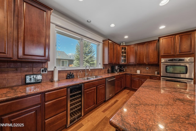 1011 Keystone Ct, Gardnerville, NV 89460 - kitchen featuring beverage cooler, a sink, appliances with stainless steel finishes, light wood-style flooring, and backsplash