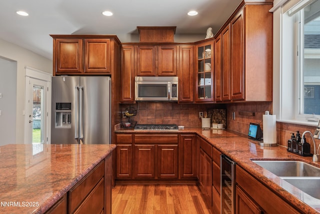 1011 Keystone Ct, Gardnerville, NV 89460 - kitchen with appliances with stainless steel finishes, a sink, light wood-style flooring, recessed lighting, and dark stone counters
