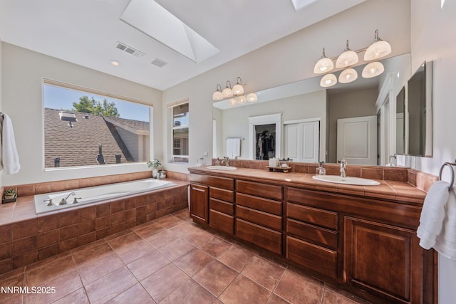 1011 Keystone Ct, Gardnerville, NV 89460 - bathroom featuring a skylight, double vanity, and a bath