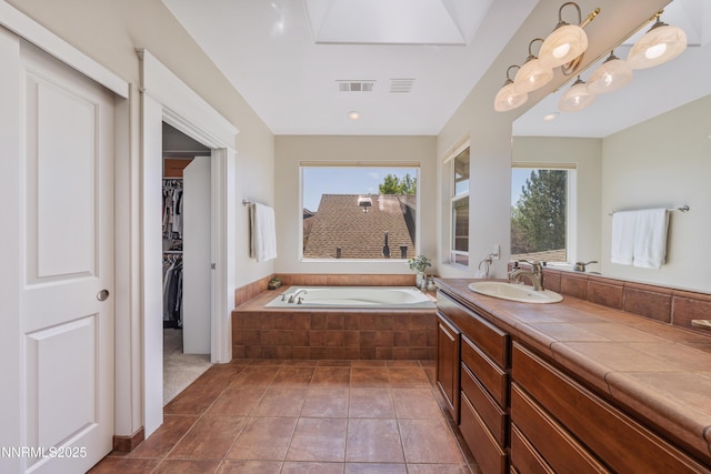 1011 Keystone Ct, Gardnerville, NV 89460 - bathroom with a bath, vanity, tile patterned floors, and a spacious closet
