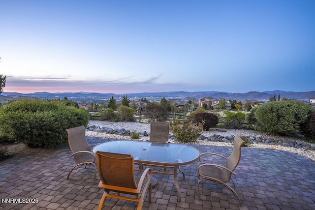 10168 Via Fiori, Reno, NV 89511 - patio terrace at dusk featuring a patio, a mountain view, and outdoor dining space
