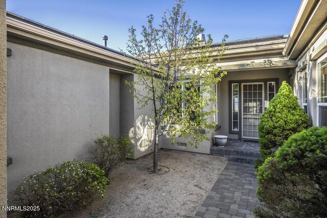 10168 Via Fiori, Reno, NV 89511 - property entrance featuring stucco siding and a patio area