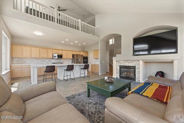 6740 Cinnamon Dr, Sparks, NV 89436 - living room featuring a fireplace, high vaulted ceiling, a ceiling fan, and recessed lighting