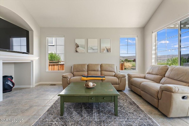 6740 Cinnamon Dr, Sparks, NV 89436 - living area featuring healthy amount of natural light, baseboards, and light stone finish flooring
