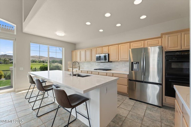 6740 Cinnamon Dr, Sparks, NV 89436 - kitchen with black appliances, a sink, light brown cabinets, backsplash, and recessed lighting