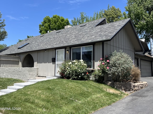 1702 London Cir, Sparks, NV 89431 - single story home featuring roof with shingles, board and batten siding, a front yard, and an attached garage