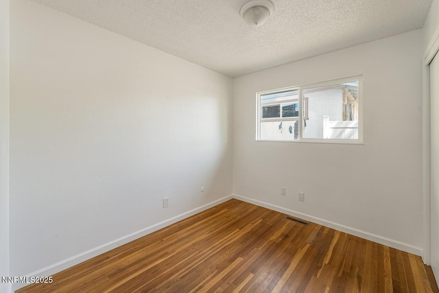 201 N Carson Meadow Dr, Carson City, NV 89701 - spare room featuring wood finished floors, baseboards, and a textured ceiling