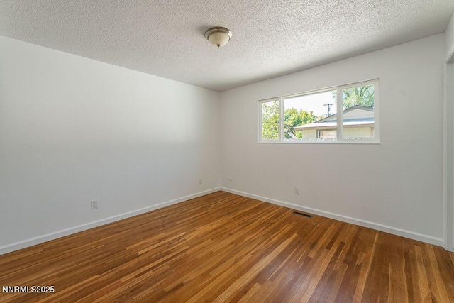 201 N Carson Meadow Dr, Carson City, NV 89701 - empty room featuring wood finished floors, baseboards, and a textured ceiling