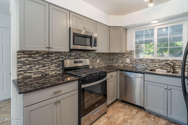 201 N Carson Meadow Dr, Carson City, NV 89701 - kitchen featuring appliances with stainless steel finishes, gray cabinetry, a sink, and backsplash