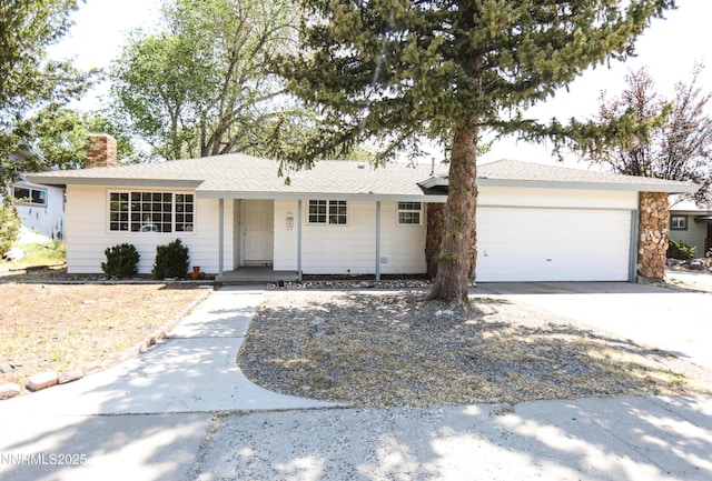 201 N Carson Meadow Dr, Carson City, NV 89701 - ranch-style home with an attached garage, a chimney, driveway, and covered porch