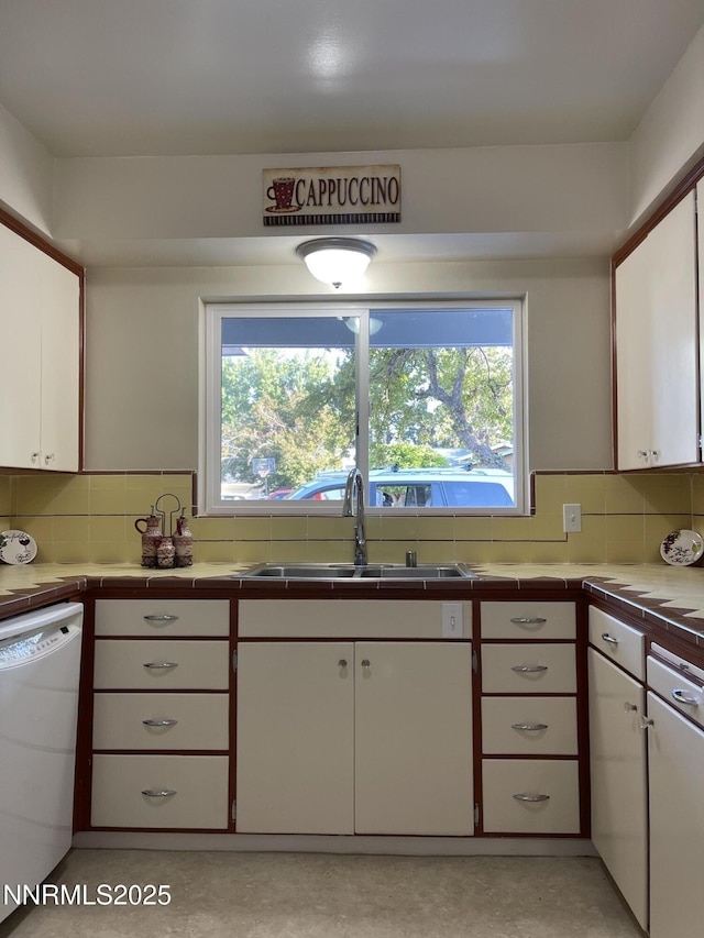 2485 Riviera St, Reno, NV 89509 - kitchen featuring dishwasher, a sink, white cabinetry, and decorative backsplash