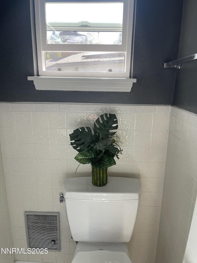 2485 Riviera St, Reno, NV 89509 - half bathroom with healthy amount of natural light, toilet, and tile walls