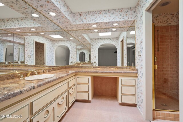 5101 Eldorado Dr, Reno, NV 89519 - full bath featuring wallpapered walls, double vanity, a stall shower, a skylight, and recessed lighting
