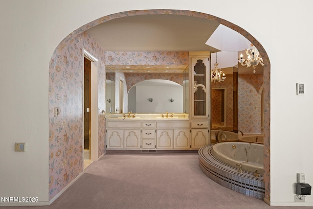 5101 Eldorado Dr, Reno, NV 89519 - full bathroom with wallpapered walls, a chandelier, double vanity, a whirlpool tub, and a shower
