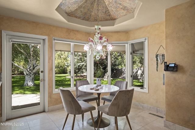 5101 Eldorado Dr, Reno, NV 89519 - dining space with a chandelier, light tile patterned floors, a raised ceiling, and baseboards