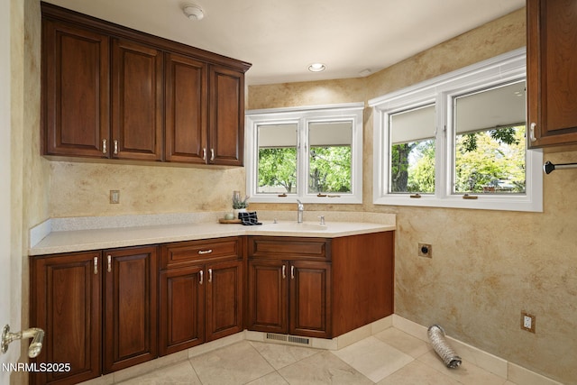 5101 Eldorado Dr, Reno, NV 89519 - kitchen with a sink, light countertops, light tile patterned floors, and baseboards