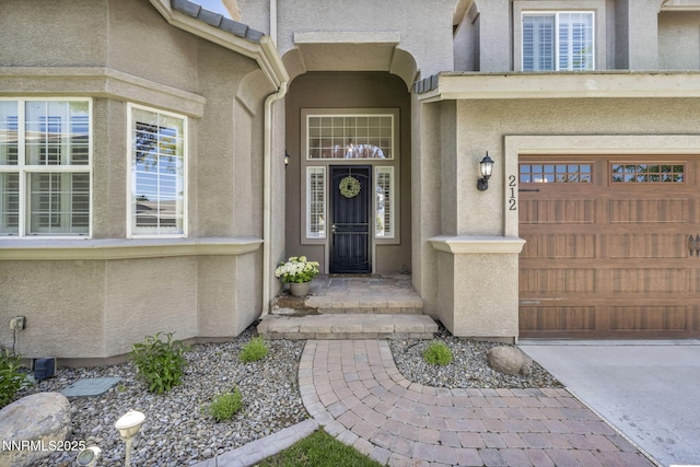 212 Portrush Ct, Dayton, NV 89403 - view of exterior entry featuring stucco siding, a garage, and driveway