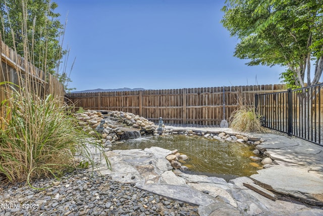 212 Portrush Ct, Dayton, NV 89403 - fenced backyard with a garden pond