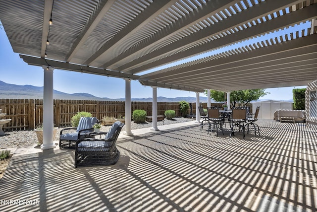 212 Portrush Ct, Dayton, NV 89403 - fenced backyard with outdoor dining area, a mountain view, and a patio area