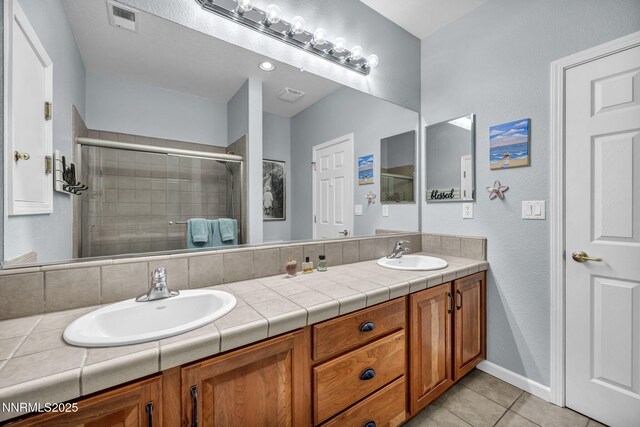 212 Portrush Ct, Dayton, NV 89403 - bathroom featuring double vanity, a stall shower, and tile patterned floors