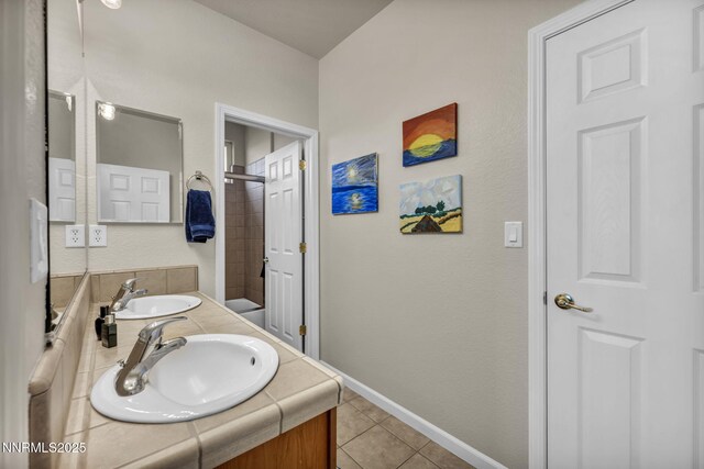 212 Portrush Ct, Dayton, NV 89403 - bathroom with vanity, tile patterned flooring, a shower, and baseboards