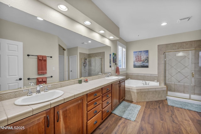 212 Portrush Ct, Dayton, NV 89403 - full bath featuring a garden tub, double vanity, wood finished floors, a stall shower, and recessed lighting