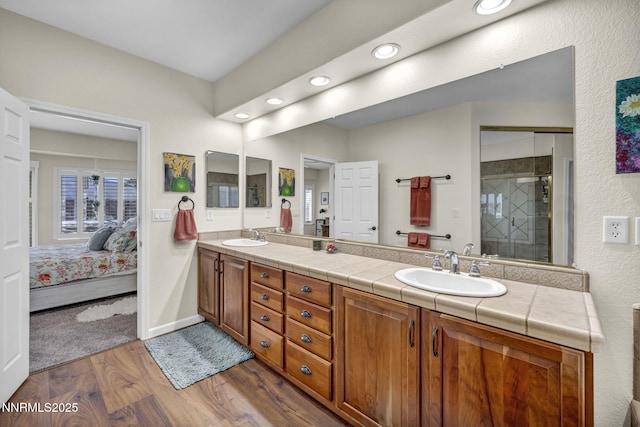 212 Portrush Ct, Dayton, NV 89403 - ensuite bathroom with wood finished floors, double vanity, recessed lighting, a shower stall, and baseboards