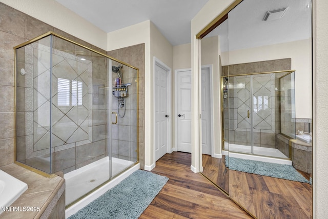 212 Portrush Ct, Dayton, NV 89403 - bathroom with a stall shower, a garden tub, and wood finished floors