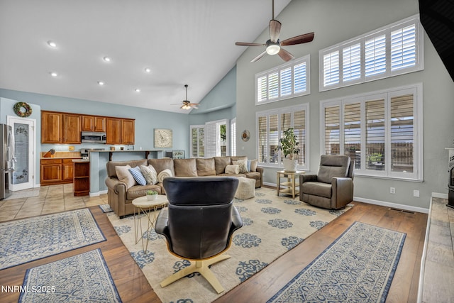 212 Portrush Ct, Dayton, NV 89403 - living room with ceiling fan, high vaulted ceiling, healthy amount of natural light, light wood-style flooring, and baseboards