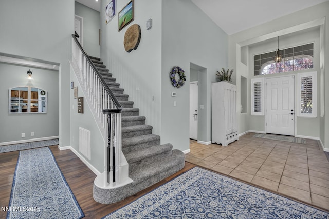 212 Portrush Ct, Dayton, NV 89403 - entryway featuring a towering ceiling, stairs, baseboards, and wood finished floors