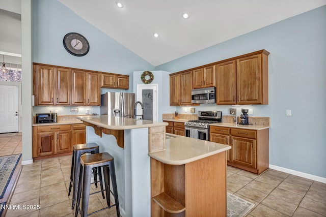 212 Portrush Ct, Dayton, NV 89403 - kitchen with stainless steel appliances, baseboards, light countertops, brown cabinets, and high vaulted ceiling