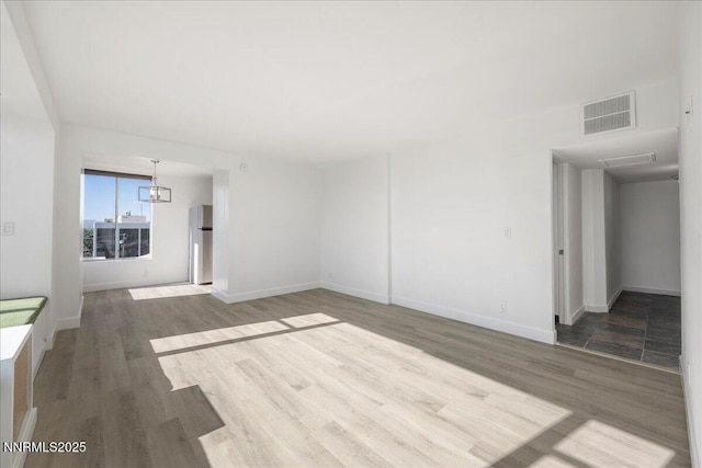 280 Island Ave Apt 906, Reno, NV 89501 - empty room featuring wood finished floors and a chandelier