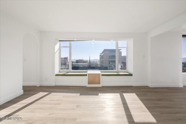 280 Island Ave Apt 906, Reno, NV 89501 - spare room with wood finished floors and arched walkways