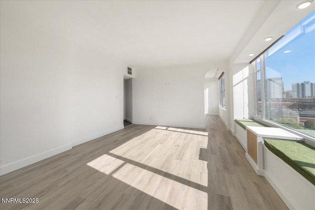 280 Island Ave Apt 906, Reno, NV 89501 - unfurnished room featuring arched walkways, light wood finished floors, a view of city, and recessed lighting