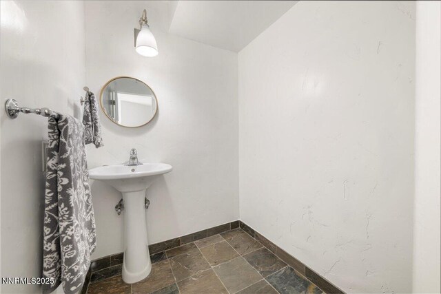 280 Island Ave Apt 906, Reno, NV 89501 - bathroom featuring baseboards and stone tile flooring