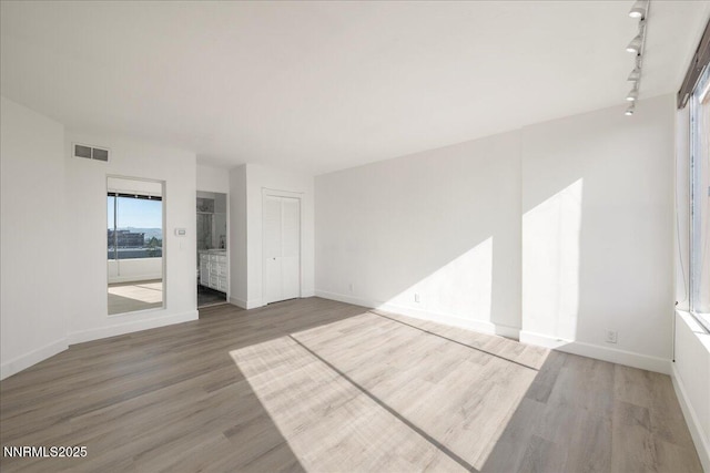 280 Island Ave Apt 906, Reno, NV 89501 - spare room featuring wood finished floors and rail lighting
