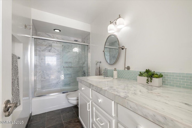 280 Island Ave Apt 906, Reno, NV 89501 - full bathroom with bath / shower combo with glass door, vanity, and backsplash