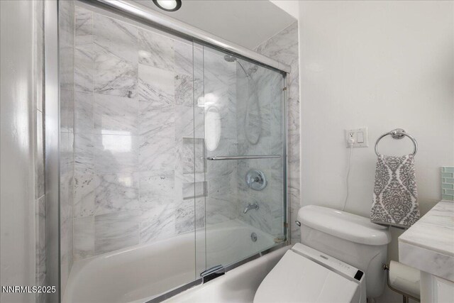 280 Island Ave Apt 906, Reno, NV 89501 - bathroom featuring bath / shower combo with glass door and toilet