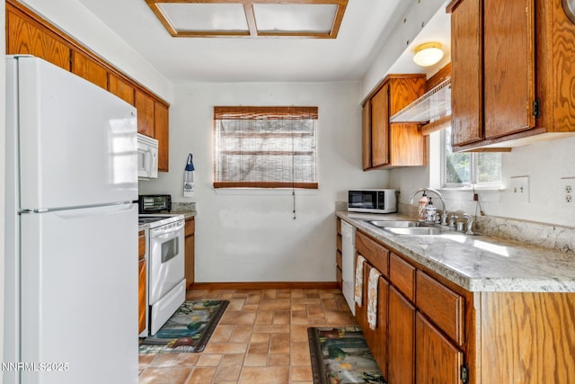 1341 Leonard Rd, Gardnerville, NV 89460 - kitchen with white appliances, a sink, light countertops, brown cabinets, and stone finish floors