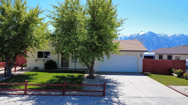 1341 Leonard Rd, Gardnerville, NV 89460 - view of front of property featuring concrete driveway, an attached garage, stucco siding, and a mountain view