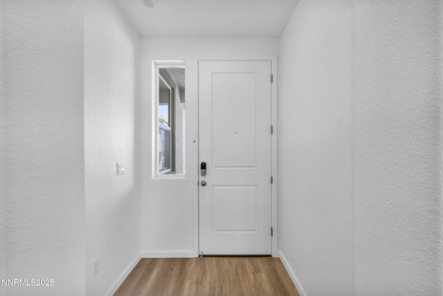 6776 Shell Ct Lot 51, Fernley, NV 89408 - doorway featuring wood finished floors, baseboards, and a textured wall
