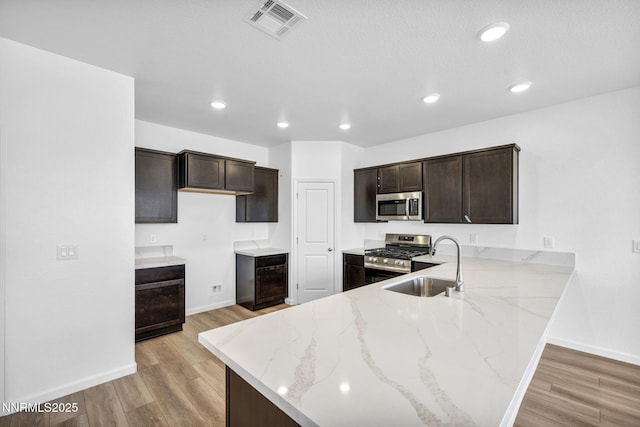 6776 Shell Ct Lot 51, Fernley, NV 89408 - kitchen with stainless steel appliances, a sink, light stone counters, baseboards, and recessed lighting