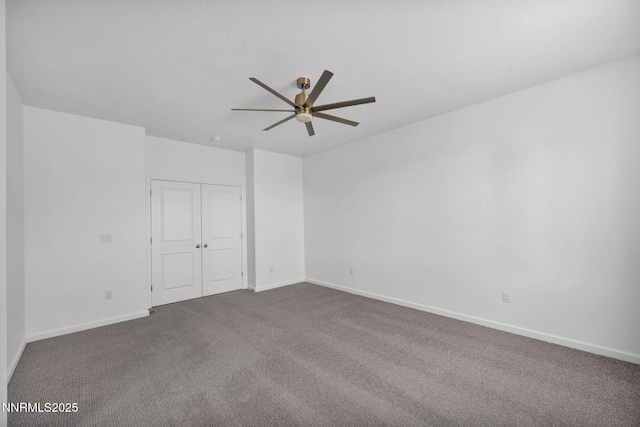 6776 Shell Ct Lot 51, Fernley, NV 89408 - unfurnished bedroom with dark colored carpet, a closet, baseboards, and a ceiling fan