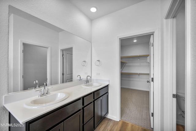 6776 Shell Ct Lot 51, Fernley, NV 89408 - full bath with wood finished floors, double vanity, toilet, and a walk in closet