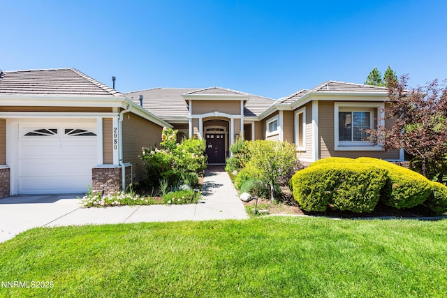 2080 St George Way, Carson City, NV 89703 - view of front facade with a garage, a front lawn, concrete driveway, and a tiled roof