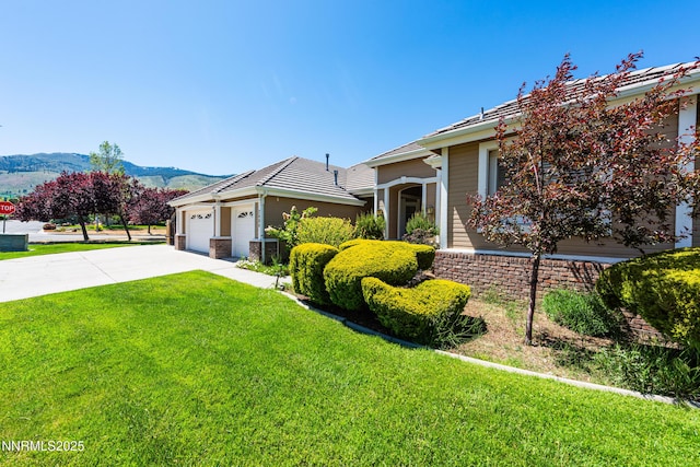 2080 St George Way, Carson City, NV 89703 - view of front of property with a front yard, driveway, a mountain view, and an attached garage