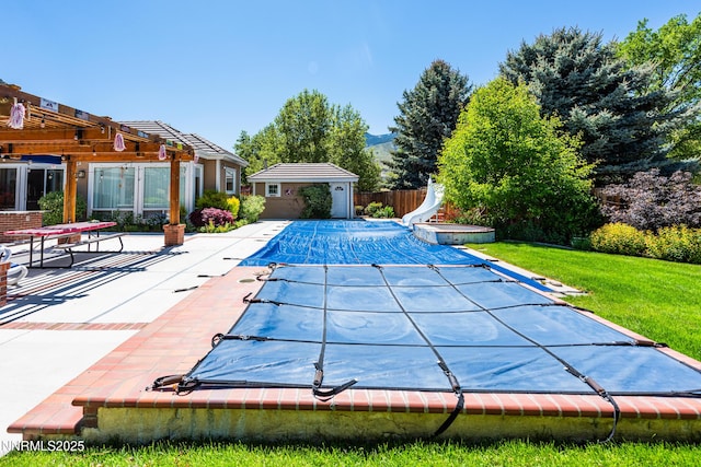 2080 St George Way, Carson City, NV 89703 - view of pool featuring a water slide, a pergola, a covered pool, a patio, and an outbuilding