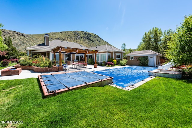 2080 St George Way, Carson City, NV 89703 - view of pool with a water slide, a mountain view, an outdoor structure, a covered pool, and a patio