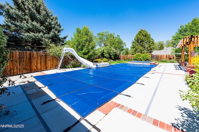 2080 St George Way, Carson City, NV 89703 - view of swimming pool with a water slide, a fenced backyard, and a patio area