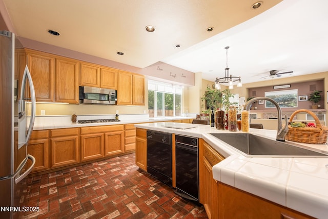 2080 St George Way, Carson City, NV 89703 - kitchen featuring stainless steel appliances, a sink, brick flooring, tile countertops, and recessed lighting